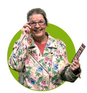 smiling wisconsin lottery winner with grey hair and glasses wearing tan blazer with colorful flowers holding up winning ticket on bright green circle background