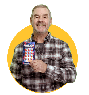 smiling wisconsin lottery winner with grey hair in brown and white plaid flannel shirt holding up winning ticket on yellow circle background
