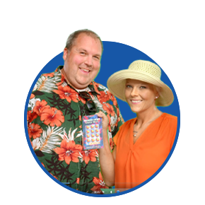 smiling wisconsin lottery winners one wearing a hawaiian shirt with orange and white flowers and the other in orange blouse and tan hat holding up winning ticket on blue circle background